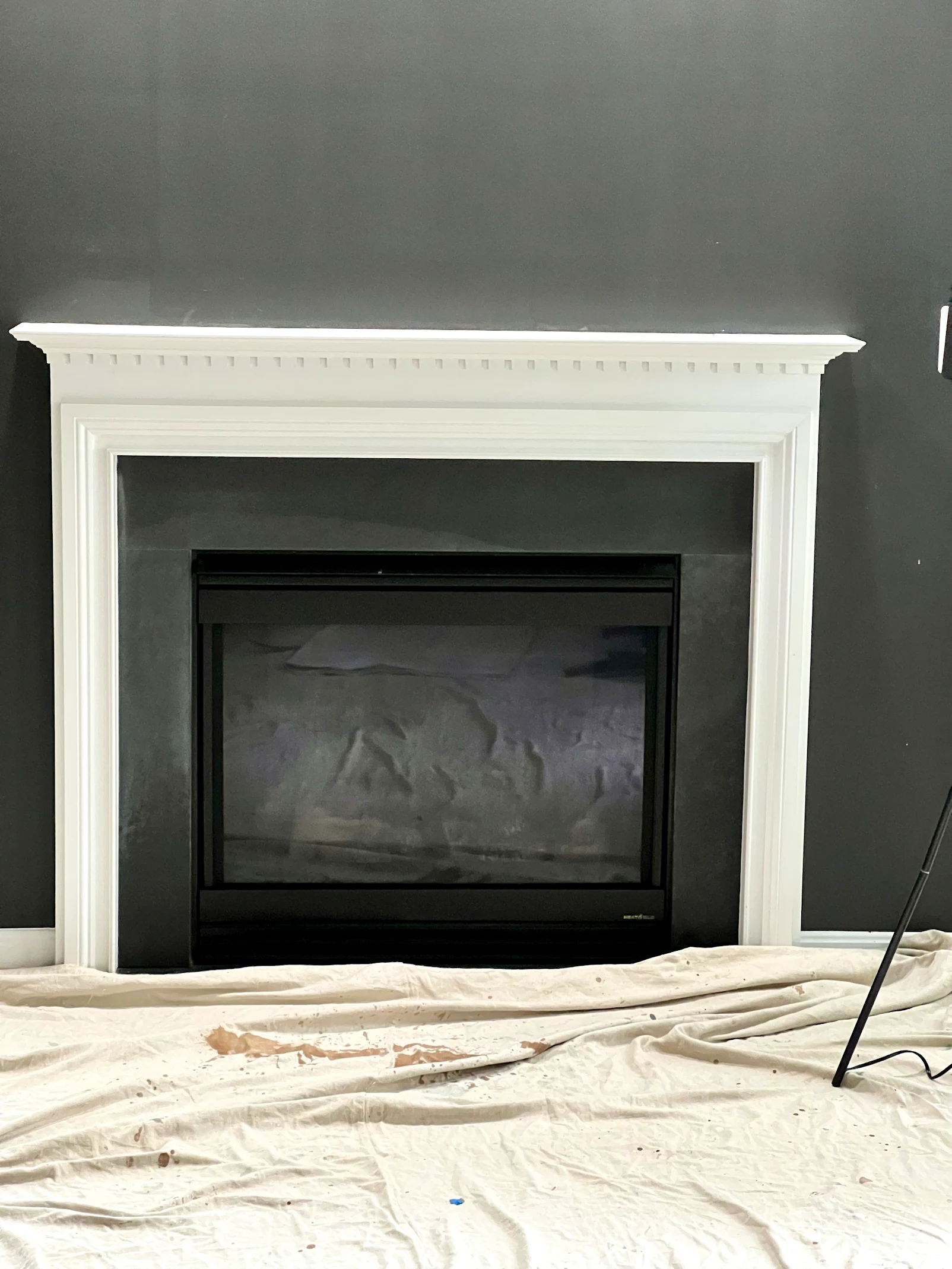 Indoor fireplace renovation with white mantel